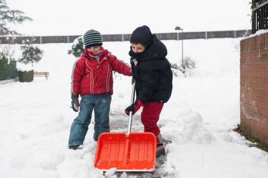 Kids shoveling snow