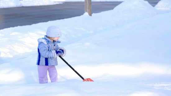 toddler shoveling snow